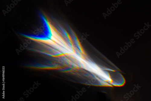 Water texture shadow with rainbow refraction of light on a black backgound. Overlay effect