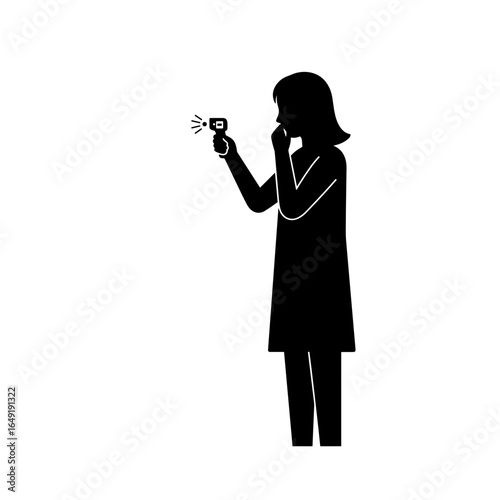 Woman checking temperature with infrared thermometer indoors  