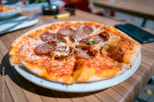 Fototapeta Naklejka Na Ścianę i Meble -  Pizza on the table of a street cafe