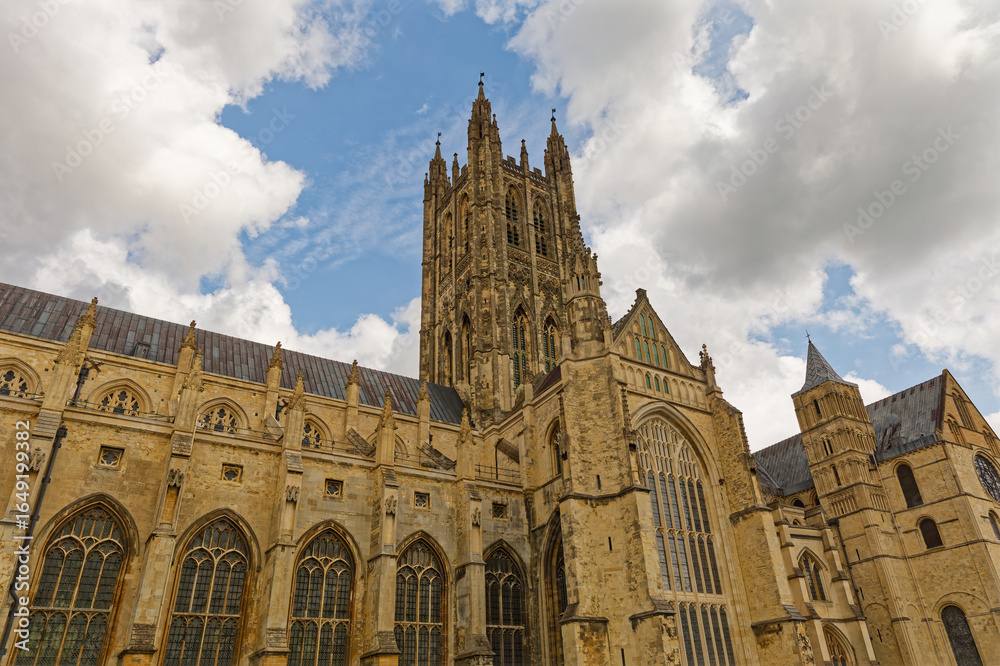 Fototapeta premium Canterbury Cathedral exterior, Uk, against a blue sky with clouds