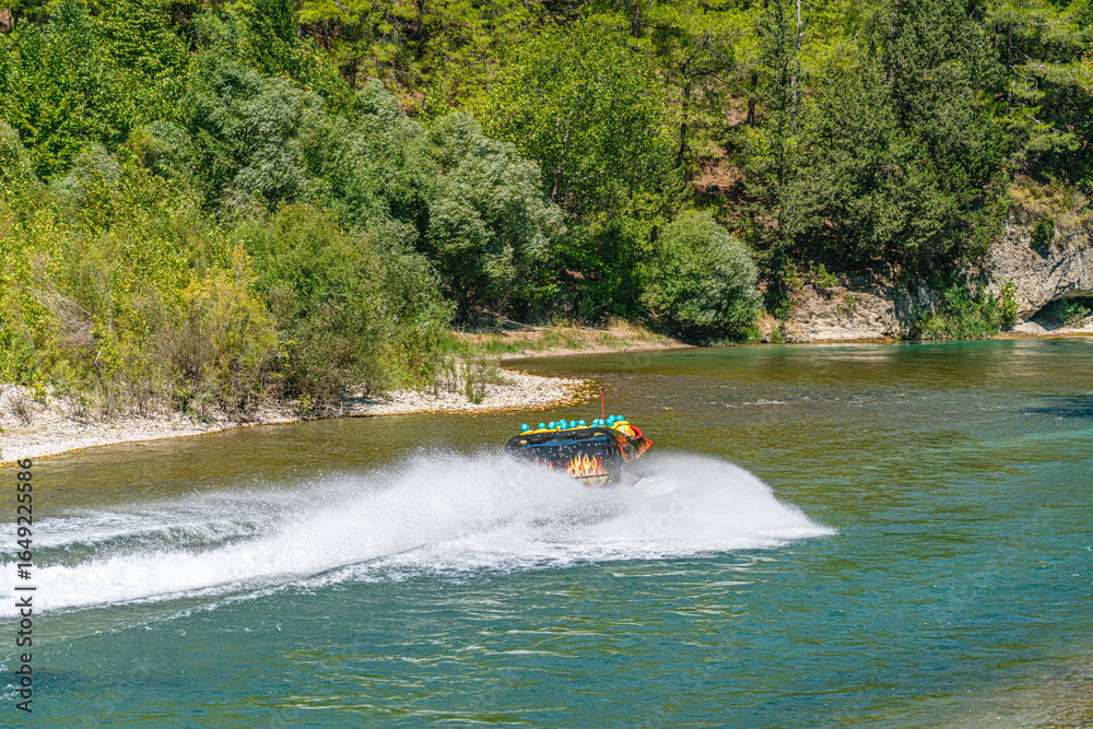 Fototapeta premium The scenic view of enjoying people in the speed boat on the river of Köprüçay, Antalya, Turkey