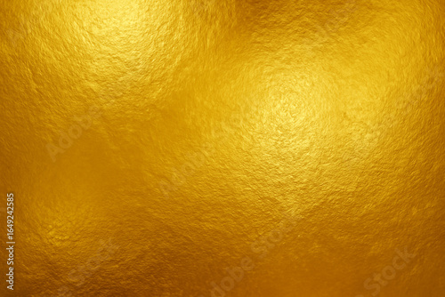 Shiny gold foil textured background with metallic reflective surface, perfect for luxury, celebration, and elegant design projects