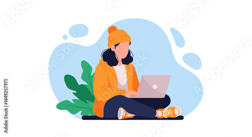 Young woman sits cross-legged on the floor, wearing a warm yellow jacket and a knitted hat, using her laptop in a cozy, minimalist home environment.