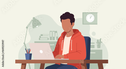 A young man wearing a red hoodie works diligently on his laptop at a wooden desk in a modern home office setting.