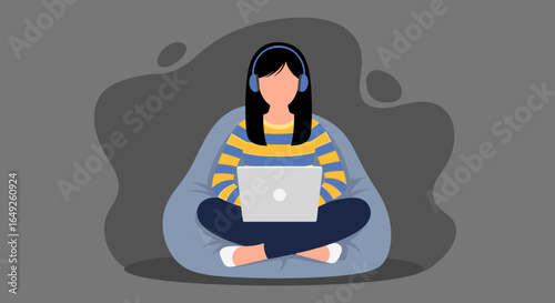 Relaxed young woman with headphones uses a laptop on a bean bag, illustrating remote work, online learning, or digital leisure in a cozy setting.