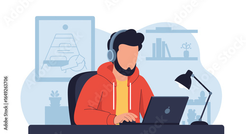 Young man wearing headphones diligently works on his laptop at a well-lit desk, focused on his task.