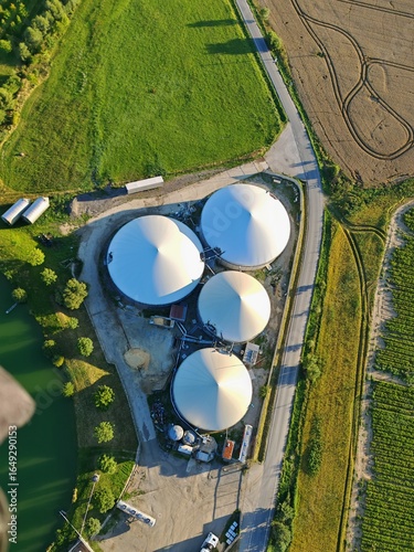 Aerial view large biogas power plant with silos and tanks for renewable energy production.