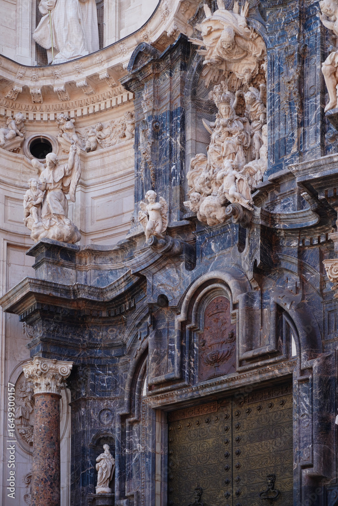 Obraz premium Baroque façade of Murcia Cathedral in Spain, featuring detailed sculptures, religious reliefs, and grand architectural elements. A masterpiece of 18th-century Spanish ecclesiastical architecture.