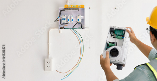Tableau sur toile Electrician installing home EV charging station