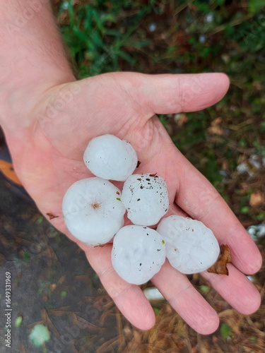 Youthful hand cradling colossal hailstones, invoking Hail Storm Awareness Day, Norse mythology's ice giants, and whimsical weather wonder