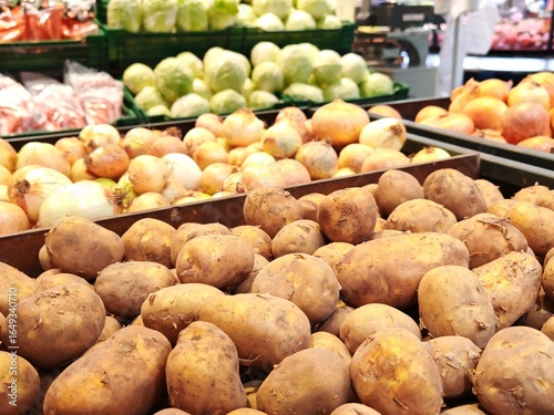 fresh potatoes on the supermarket counter. Soft focused shot of fresh potatoes in boxes in grocery department store, supermarket, local shop. Organic food