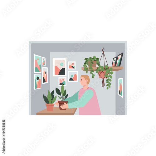 Happy young man enjoying his indoor gardening hobby arranging potted plants in a stylish art-filled room.