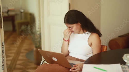 Unhappy young indian woman student or freelancer with closing eyes suffering headache painful feelings chronic migraine high or low pressure after hard laptop computer work at home