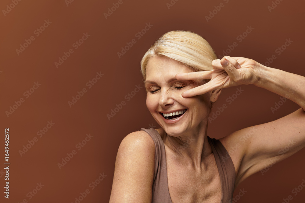 Fototapeta premium Embracing joy and beauty, a senior woman shares her cheerful spirit with a playful pose