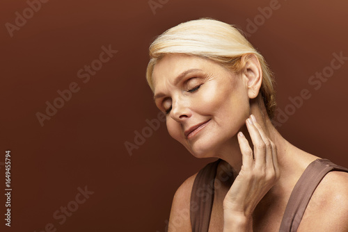 Fotografie Elegant senior woman basking in soft light, showcasing timeless beauty and grace