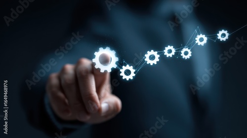 Hand pointing to interconnected gears for workflow