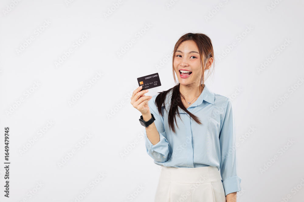 Smiling young Asian woman holding credit card payment, happy with bank card, shows her debit card for online business, A woman holds a dark credit card, isolated studio white background