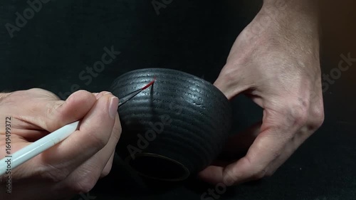 kintsugi gold cracks restoration process, Japanese black bowl fixed with the antique kintsukuroi restoration technique, the beauty of imperfections, representation of a trauma