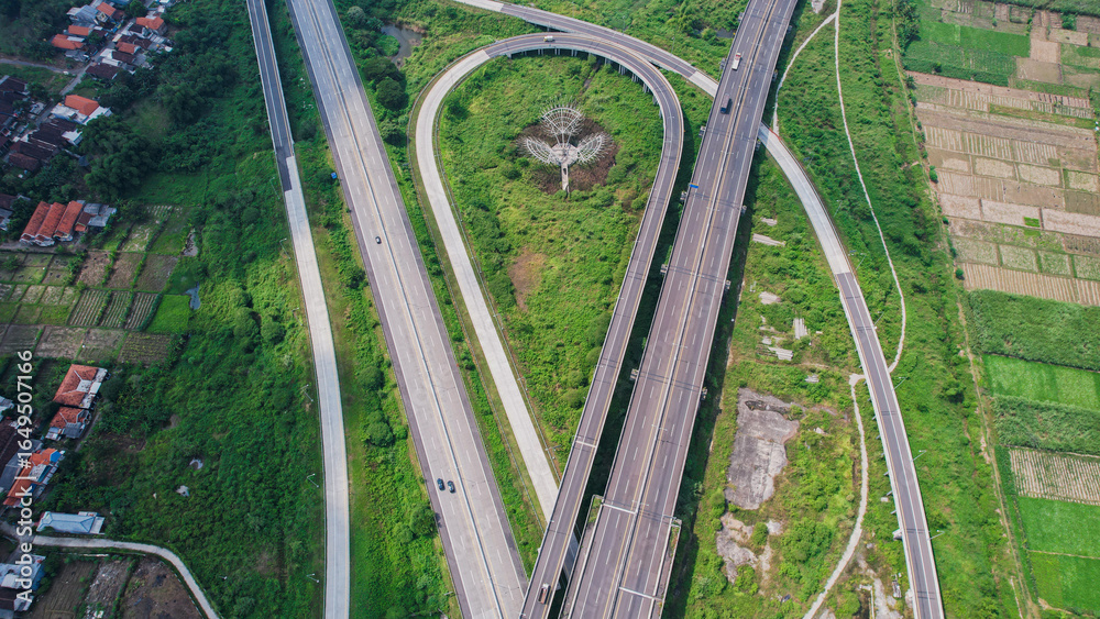 Obraz premium Scenic Aerial View of a Sumo Toll Road and Green Field at Surabaya, East Java Indonesia