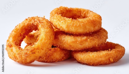 Stacked onion rings, golden-brown and crispy,  stacked on white background
