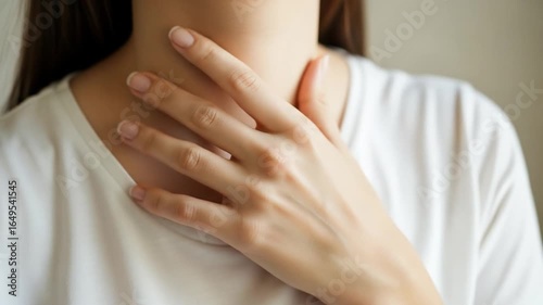 Woman suffering from sore throat or thyroid gland problem, health concept