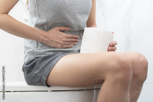 Photography Woman holding toilet paper go to toilet.