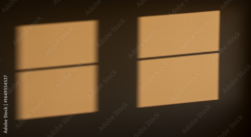 Obraz premium Warm golden sunlight casts soft windowpane shadows on a textured wall, creating a serene and inviting atmosphere.