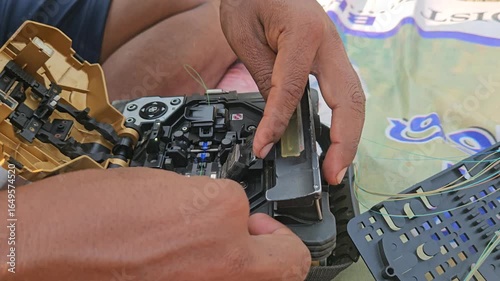 A fiber optic fusion splicer machine in action, captured in 4K 30fps in India, as a technician carefully joins optical cables to ensure a stable internet signal with precise, low-loss connections.