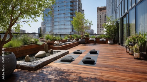 Rooftop yoga deck with lush landscaping and city views.