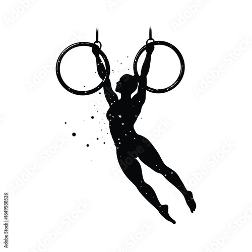 Silhouette of a female aerialist on gymnastic rings
