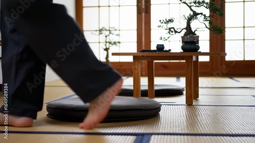Barefoot person walking on tatami mats in Japanese room.
