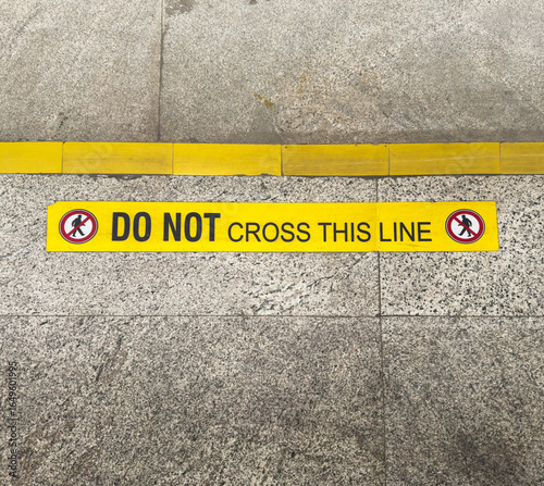Do not cross this line signage on the floor in the metro stations to warn commuters to not go beyond the line until the train arrives.