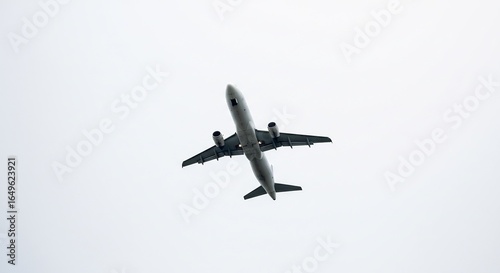 Airplane ascends powerfully against a pale overcast sky. AI Generated