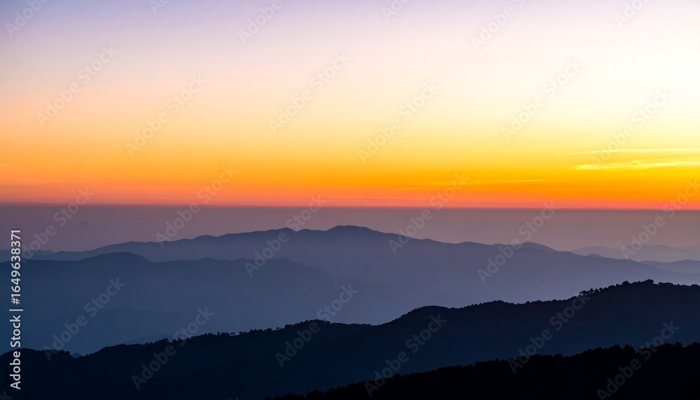 Obraz premium Layered mountain ranges at sunrise.