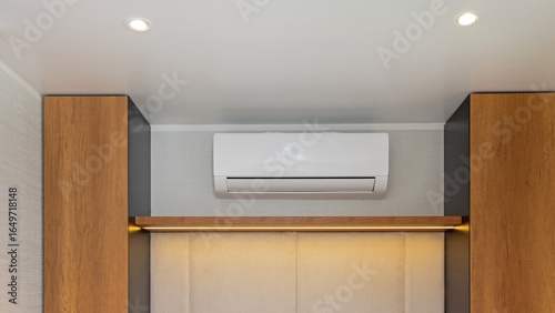 White Air Conditioner Mini Split Unit Mounted at Wall in Bedroom