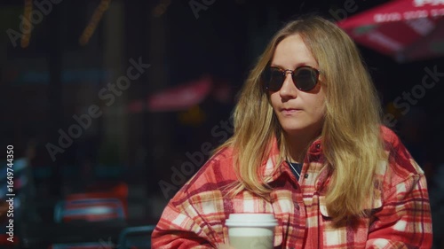 Woman with Sunglasses Drinking Coffee at Café