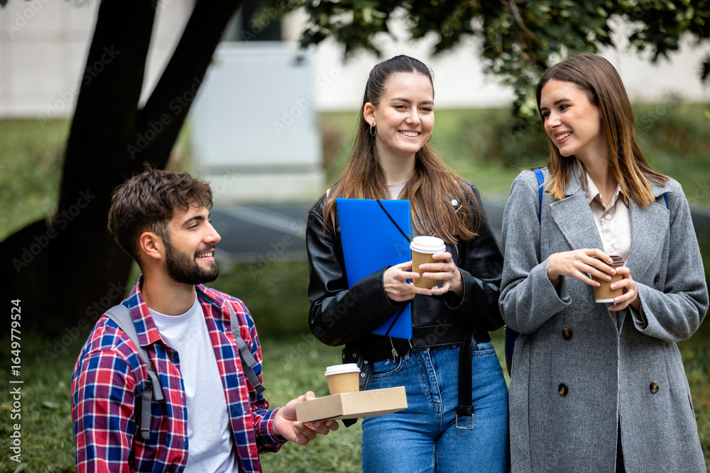 Obraz premium Students Laughing with Books and Coffee on College Campus