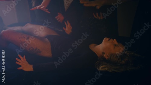 a writhing woman is sacrificed on an altar during a satanic ritual