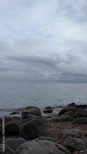 gray clouds over water, vertical video for background and wallpaper