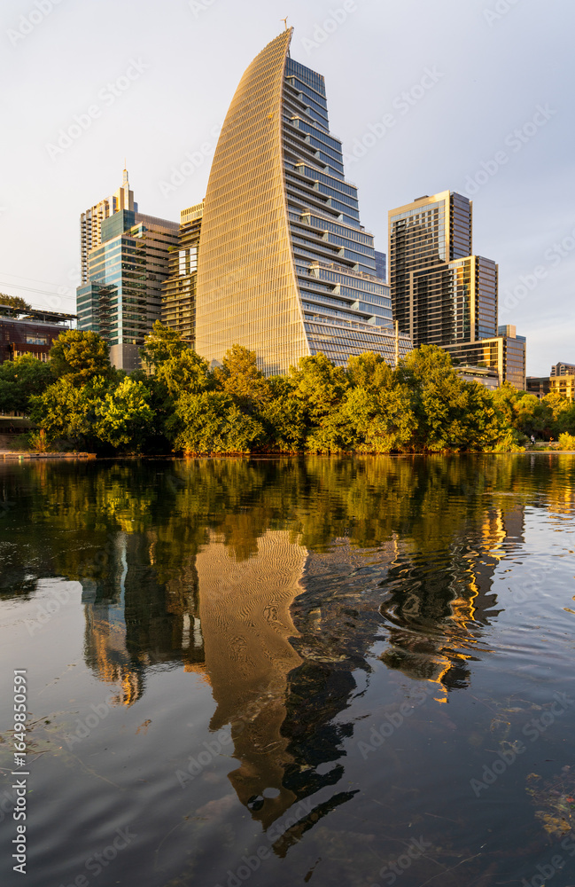 Fototapeta premium View of the city skyline of Austin Texas in summer 2025 from Lady Bird Johnson Lake with Sail building
