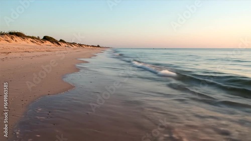 Serene Sunset Beachscape: Coastal Calm at Dawn