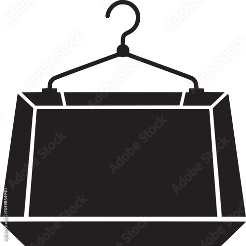 A black silhouette of a boxy garment bag hanging from a black hanger against a white background space