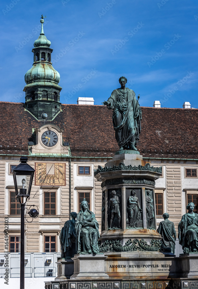 Image of a church steeple and building with statues and a fountain in front of it in Vienna. Image of a church steeple and building with statues and a fountain in front of it in Vienna.