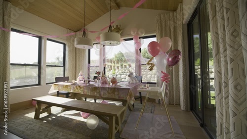 Wide shot of beautiful pink birthday set up in kitchen