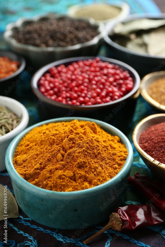 Different aromatic spices on blue tablecloth, closeup Different aromatic spices on blue tablecloth, closeup