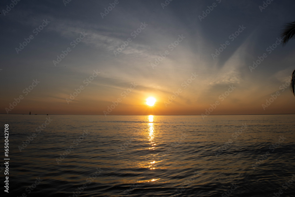 Beautiful sunset on the sea beach with coconut tree for travel in holiday Beautiful sunset on the sea beach with coconut tree for travel in holiday