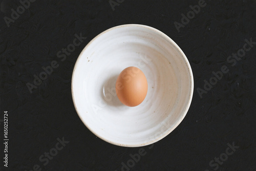 Brown Egg in White Ceramic Bowl Top View