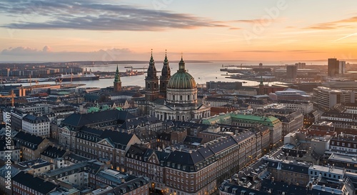 Aerial view of Copenhagen cityscape at dawn, showcasing architecture and harbor views