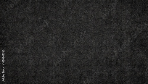 Dark gray textured surface with subtle variations in tone