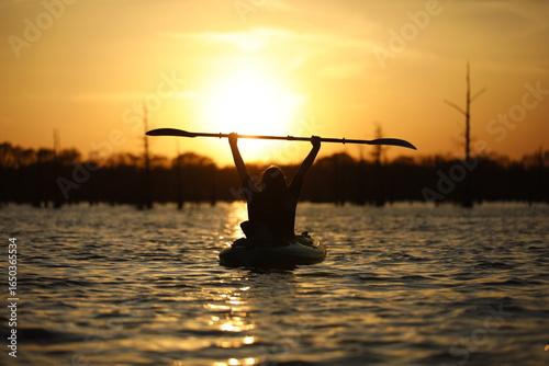Kayaker in the Golden Sun Set of the Louisiana Swamps 